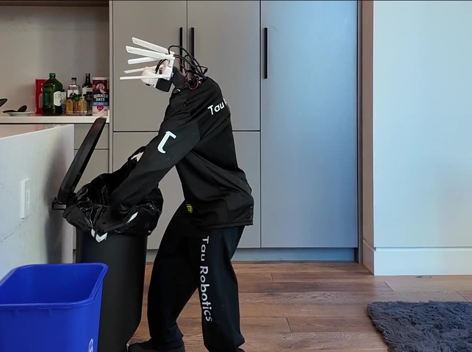 Robot hình người thay túi rác trong khu bếp của căn hộ